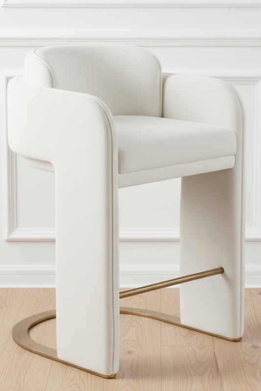 White bar stool with gold legs on a wooden floor