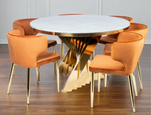 white marble top round gold dining table for 6 with orange  chairs